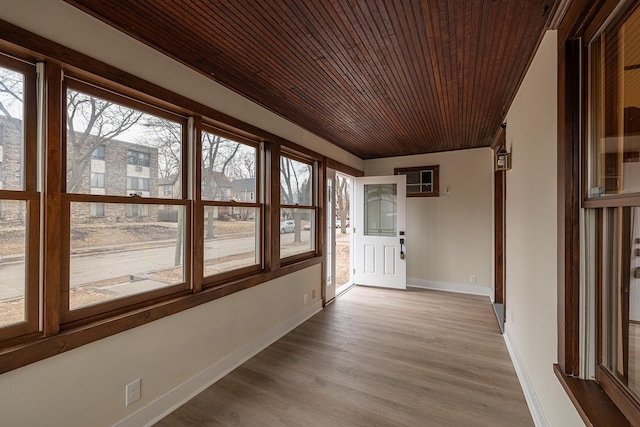 unfurnished sunroom featuring wooden ceiling