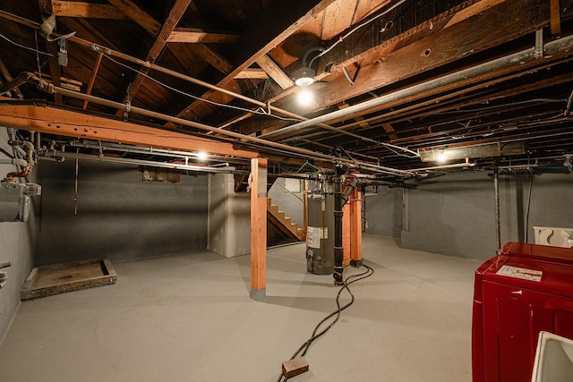 unfinished below grade area featuring water heater