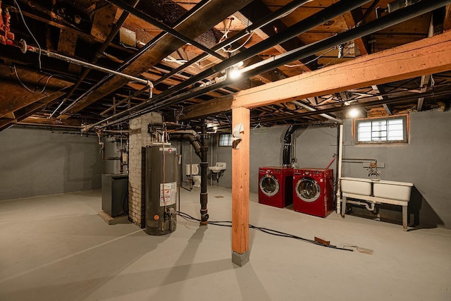 below grade area with washing machine and dryer, gas water heater, and a sink