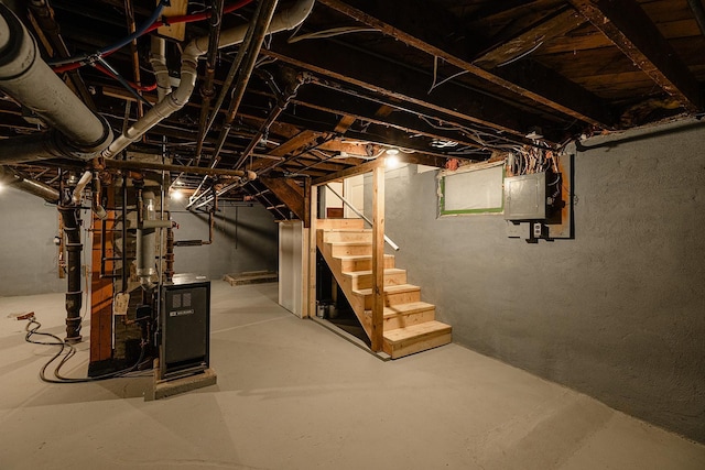 unfinished basement with stairs and electric panel