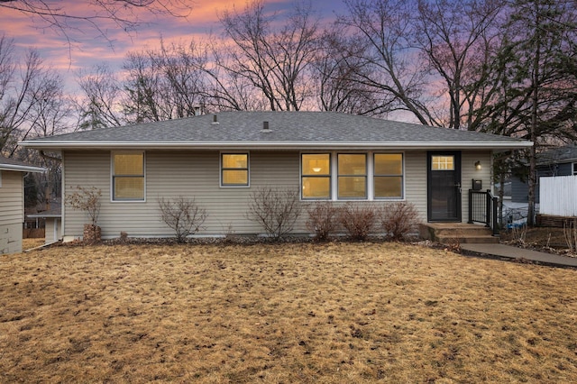 single story home featuring a shingled roof