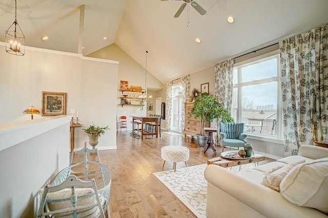 living area featuring recessed lighting, wood finished floors, high vaulted ceiling, baseboards, and ceiling fan with notable chandelier