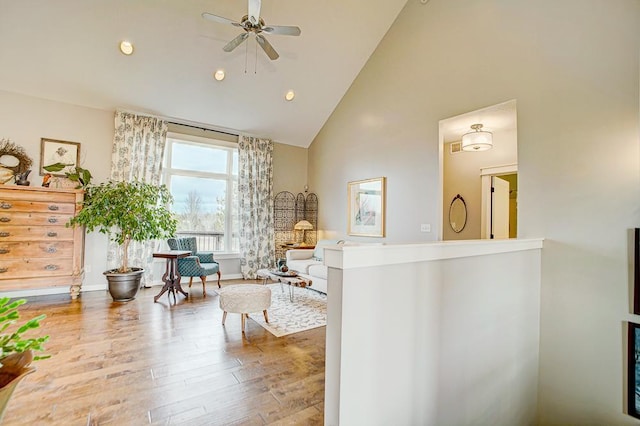 interior space with high vaulted ceiling, wood finished floors, a ceiling fan, and recessed lighting