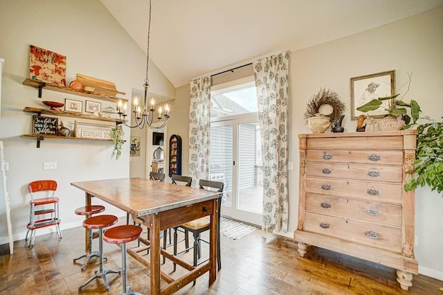 dining room featuring an inviting chandelier, wood-type flooring, baseboards, and high vaulted ceiling