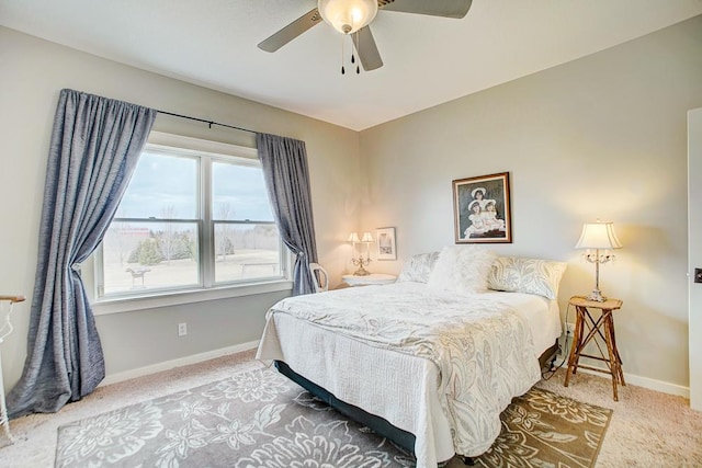 carpeted bedroom with baseboards and a ceiling fan