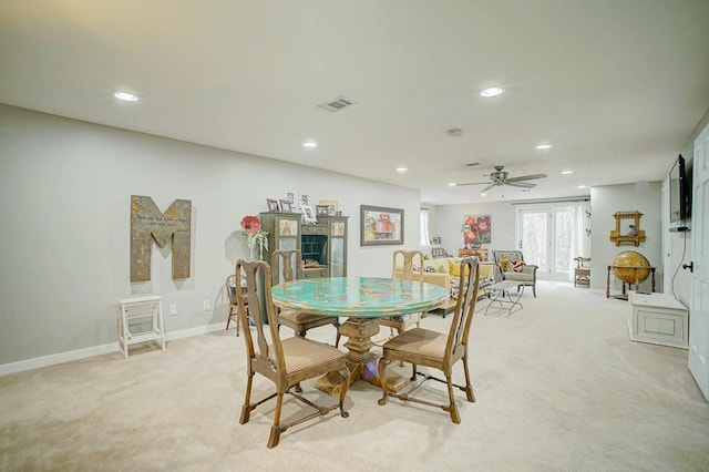 dining space with light carpet, visible vents, and recessed lighting