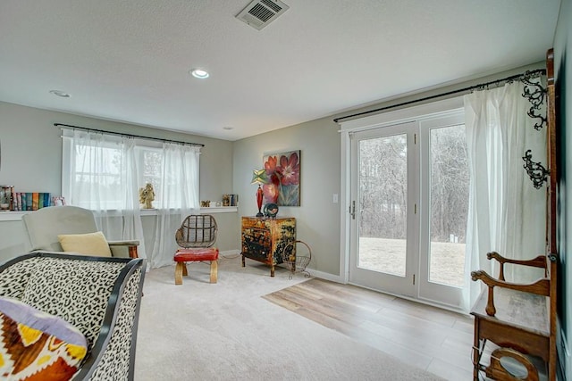 sitting room with recessed lighting, visible vents, and baseboards