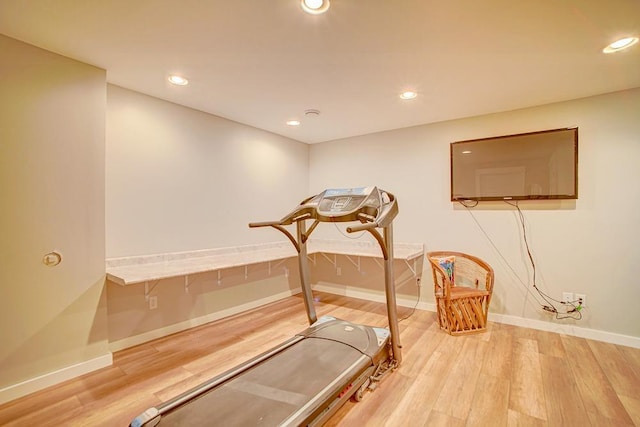 workout room with baseboards, wood finished floors, and recessed lighting