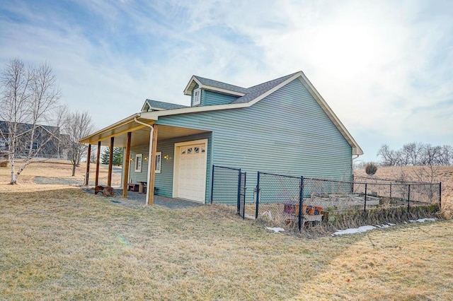 view of home's exterior with driveway, a yard, an attached garage, and fence