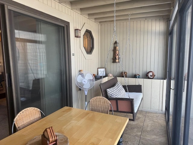 sunroom featuring beamed ceiling