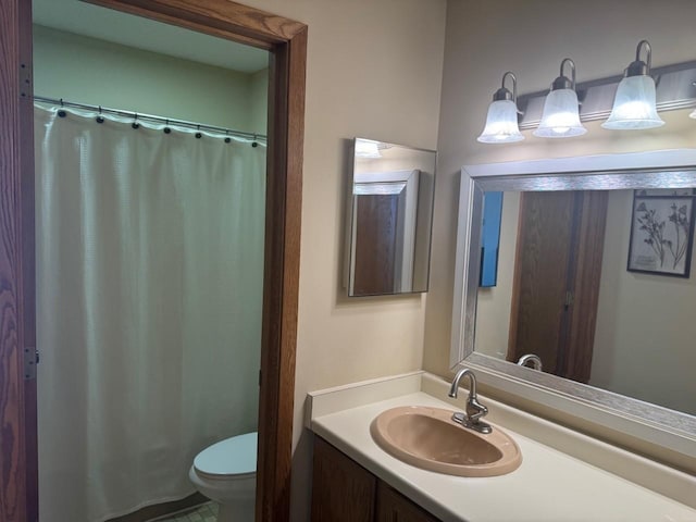 bathroom featuring toilet and vanity