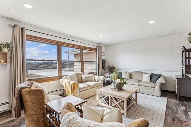 living room with a baseboard radiator, a textured ceiling, wood finished floors, and recessed lighting