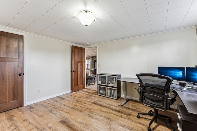 office featuring baseboards and light wood finished floors