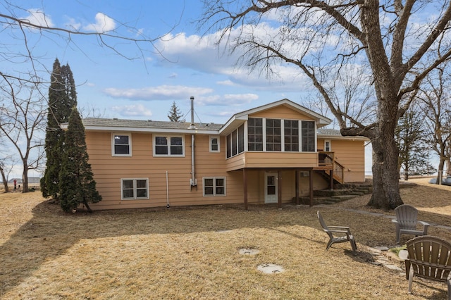 back of house featuring a sunroom and stairway