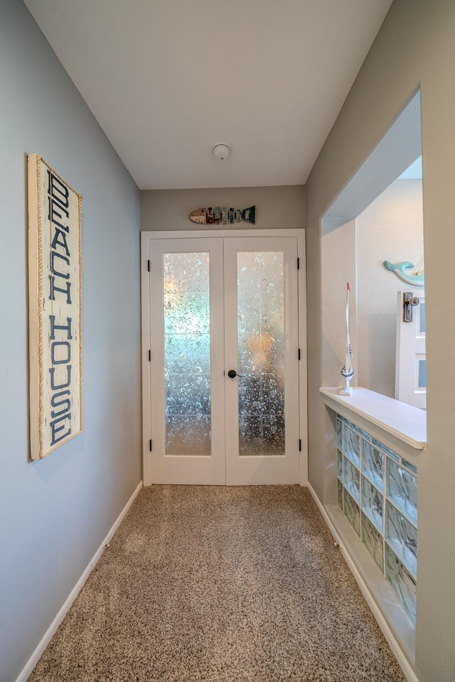 doorway with carpet, baseboards, and french doors