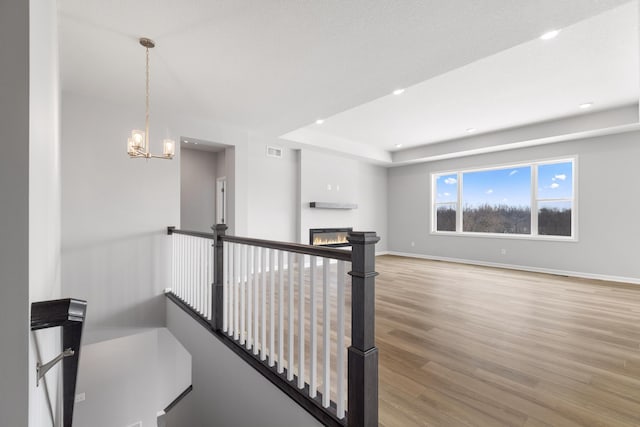 10720 Harbor Ln N, Maple Grove, MN 55369 - interior space featuring visible vents, baseboards, an upstairs landing, an inviting chandelier, and light wood-style flooring