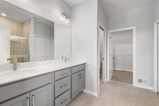 10720 Harbor Ln N, Maple Grove, MN 55369 - full bathroom featuring visible vents, a sink, baseboards, and double vanity