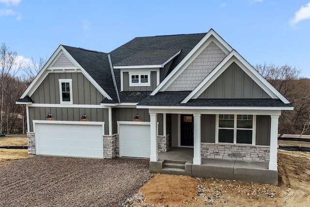 10720 Harbor Ln N, Maple Grove, MN 55369 - view of front of house with board and batten siding, driveway, roof with shingles, a garage, and stone siding