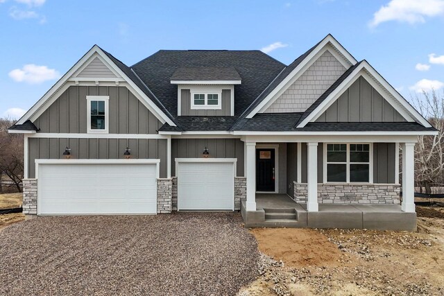 10720 Harbor Ln N, Maple Grove, MN 55369 - view of front facade with a shingled roof, board and batten siding, and stone siding