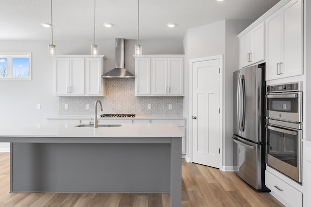 10720 Harbor Ln N, Maple Grove, MN 55369 - kitchen featuring wall chimney exhaust hood, appliances with stainless steel finishes, light countertops, light wood-style flooring, and recessed lighting