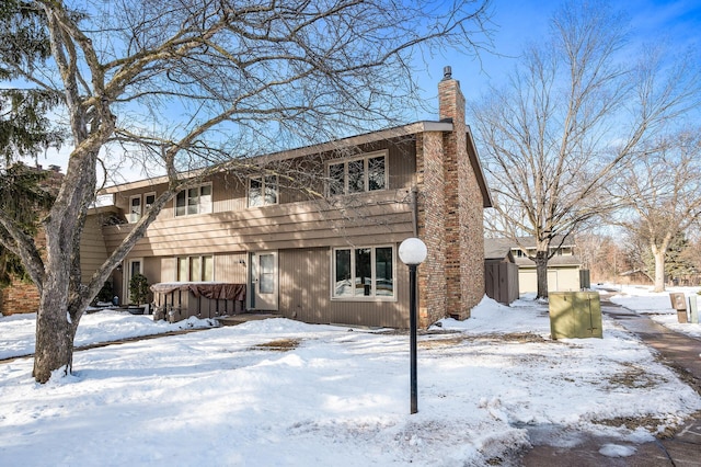 view of front facade with a hot tub and a chimney