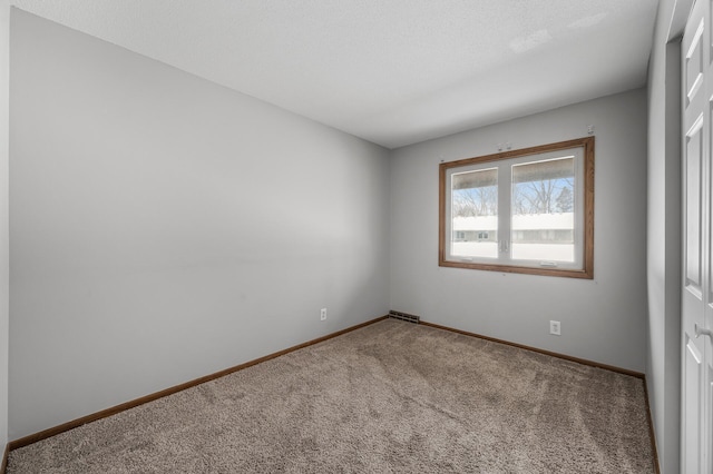 empty room with carpet floors and baseboards