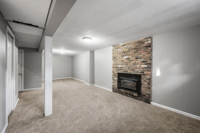 finished basement with a textured ceiling, carpet floors, a fireplace, and baseboards