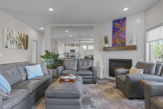 living area featuring a fireplace, carpet flooring, and recessed lighting