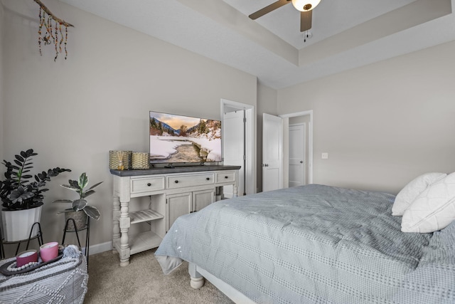 bedroom featuring light colored carpet, ceiling fan, and baseboards