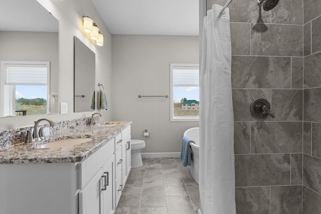 bathroom with a healthy amount of sunlight, a sink, and a tile shower