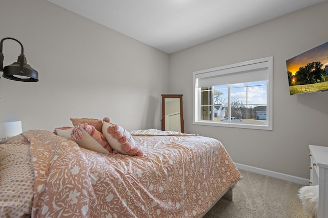 bedroom featuring carpet floors and baseboards