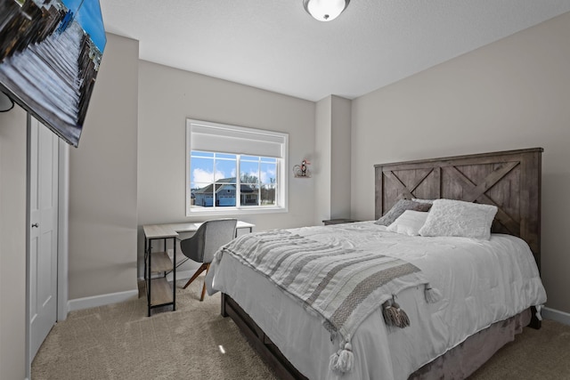 carpeted bedroom featuring baseboards