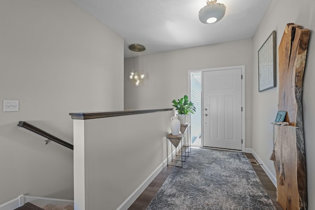 entryway featuring dark wood-style floors and baseboards