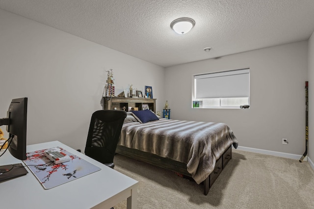 bedroom with carpet, baseboards, and a textured ceiling