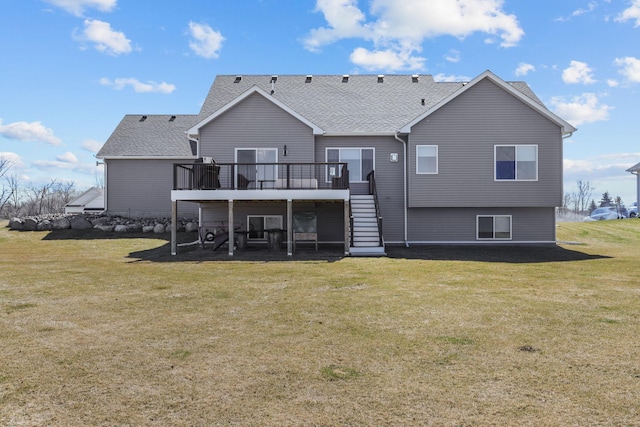 rear view of property with roof with shingles, a lawn, stairway, and a wooden deck