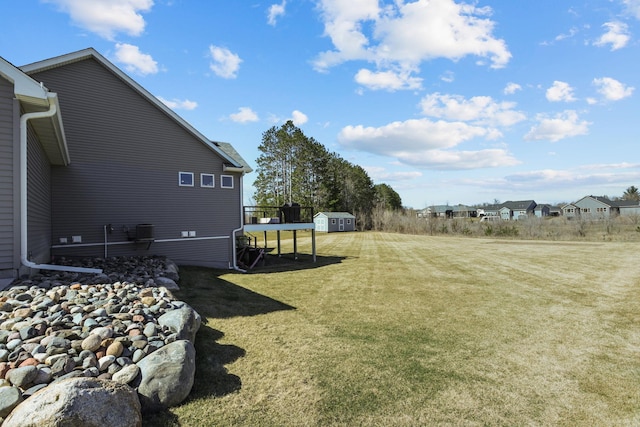 view of yard featuring an outdoor structure and a storage unit