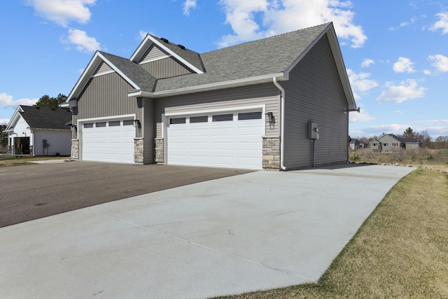 view of front of property featuring an attached garage, stone siding, aphalt driveway, and a shingled roof