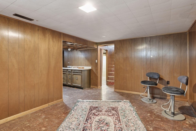 interior space with visible vents and wood walls