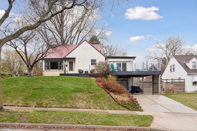 view of front facade with a garage, a carport, a wooden deck, driveway, and a front lawn
