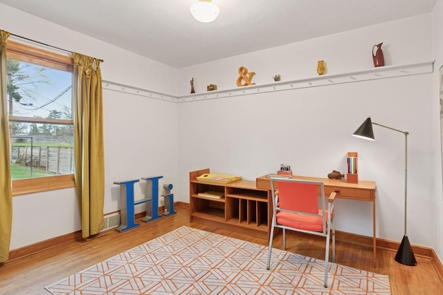 interior space featuring baseboards, visible vents, and wood finished floors