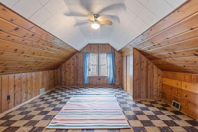 additional living space featuring tile patterned floors, wooden walls, and lofted ceiling