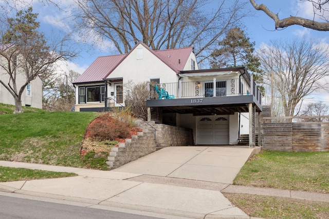 view of front facade with stucco siding, driveway, stairs, and a garage
