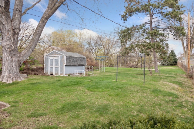 view of yard with fence, an outbuilding, and a storage shed