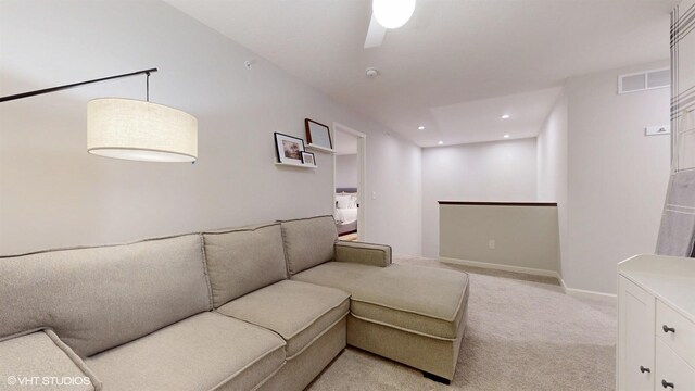 living area with recessed lighting, visible vents, light carpet, and baseboards