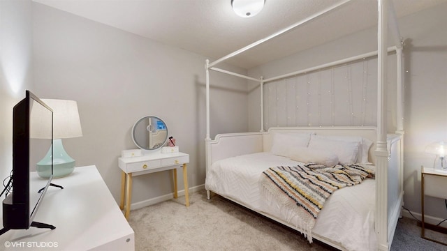 carpeted bedroom featuring baseboards