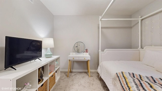 carpeted bedroom featuring baseboards