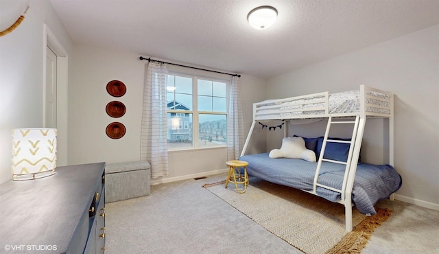 carpeted bedroom with a textured ceiling, visible vents, and baseboards