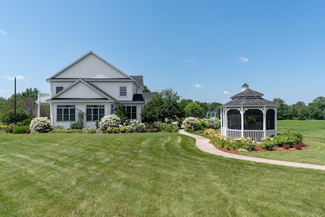 view of front of home featuring a front lawn and a gazebo