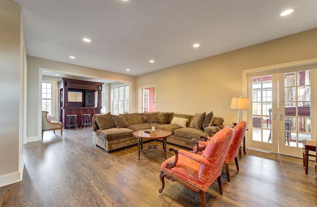 living area featuring baseboards, french doors, wood finished floors, and recessed lighting