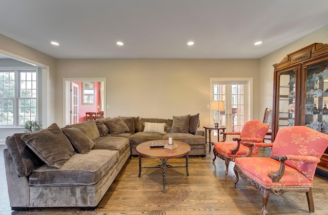 living area featuring plenty of natural light, french doors, wood finished floors, and recessed lighting